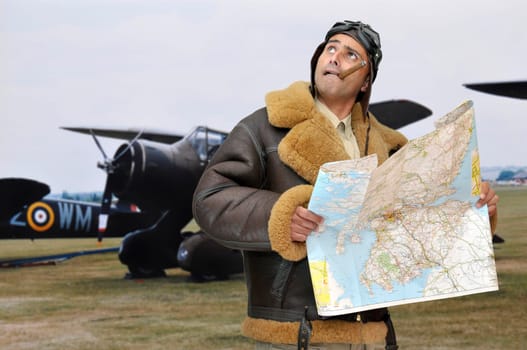 WWII fighter pilot with map looking to the sky