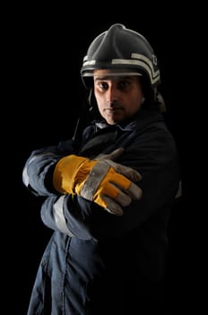 Fireman in uniform isolated in black