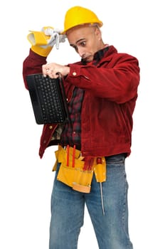 Confused construction worker with laptop isolated in white