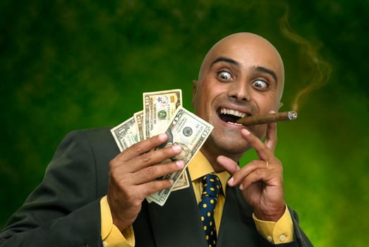 Businessman with money isolated against a dark green background