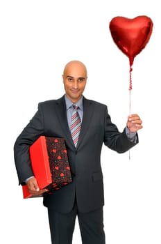 Man in suit with valentine's gift and heart shaped balloon
