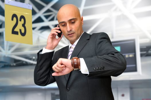 Businessman with cellphone in the airport