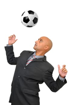 Businessman playing with a soccer ball isolated in white