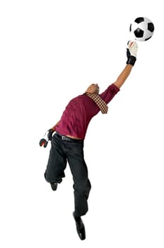 Businessman goalkeeper with gloves in a acrobatic pose with a soccer ball isolated in white