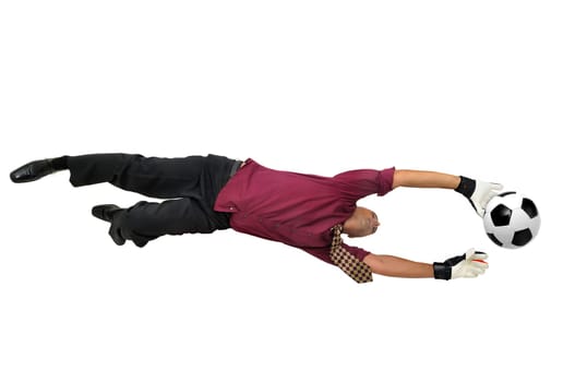 Businessman goalkeeper with gloves in a acrobatic pose with a soccer ball isolated in white