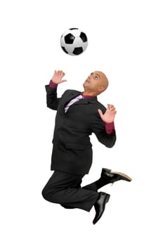 Businessman in a acrobatic pose with a soccer ball isolated in white