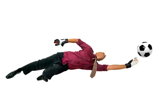 Businessman goalkeeper with gloves in a acrobatic pose with a soccer ball isolated in white