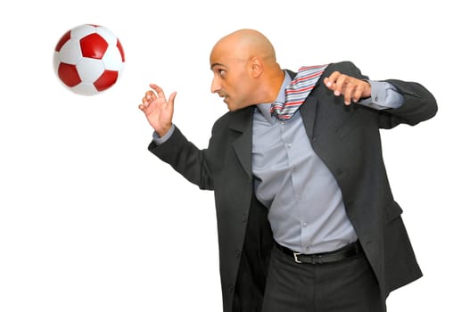 Businessman playing with a soccer ball isolated in white