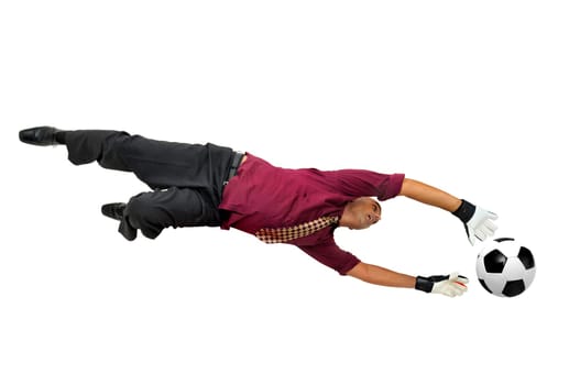 Businessman goalkeeper with gloves in a acrobatic pose with a soccer ball isolated in white