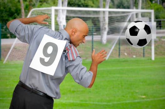 Businessman playing a soccer match