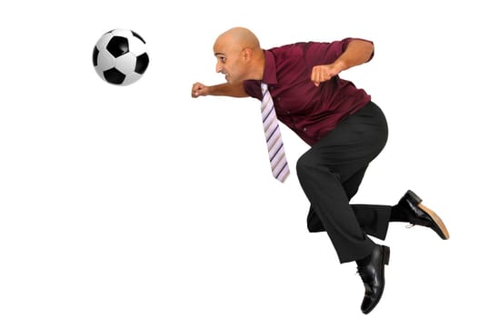 Businessman in a acrobatic pose with a soccer ball isolated in white