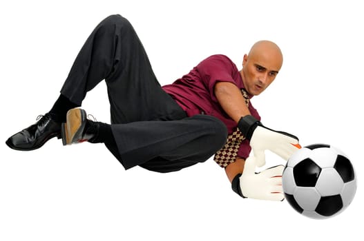 Businessman goalkeeper with gloves and ball in a acrobatic save isolated in white