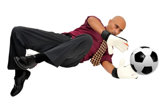 Businessman goalkeeper with gloves and ball in a acrobatic save isolated in white