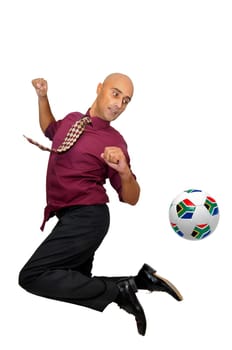 Businessman in a acrobatic pose with a soccer ball isolated in white