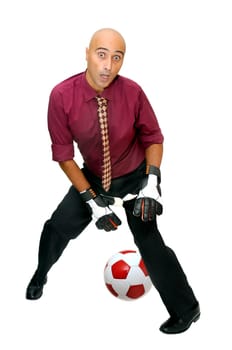 Businessman goalkeeper with gloves trying with no success to stop a ball isolated in white