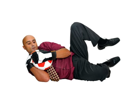 Businessman goalkeeper with gloves and ball in a acrobatic save isolated in white