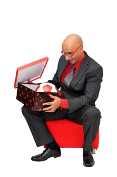 Businessman openning a gift with a soccer ball isolated in white