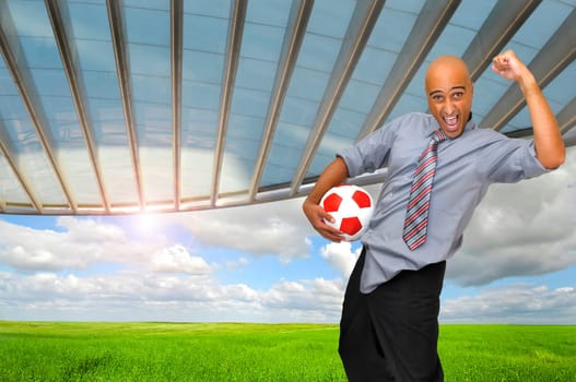 Businessman with soccer ball in a stadium like background
