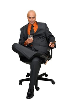 Mature businessman in a chair isolated in white