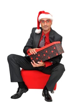 Businessman with gift isolated against a white background