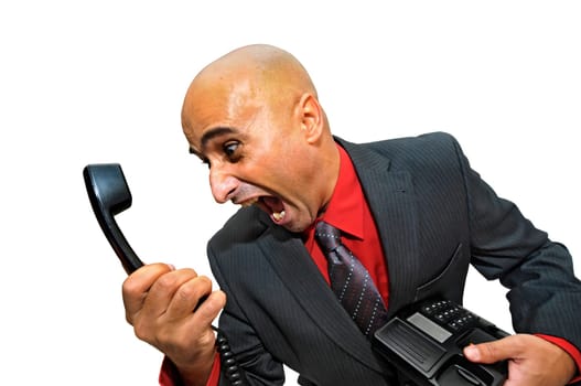 Angry businessman shouting at a telephone isolated in white