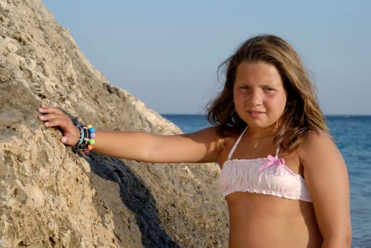 Beautiful young girl posing in the beach