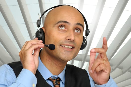 Businessman speaking with headset in the office