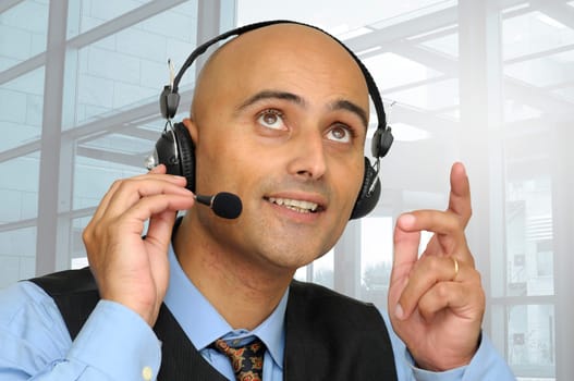 Businessman speaking with headset in the office