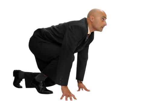 Businessman in a race start position isolated in white
