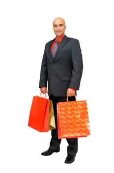 Elegant businessman with shopping bags isolated in white