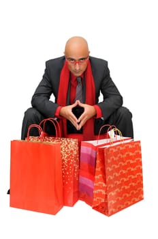 Businessman posing with shopping bags isolated in white