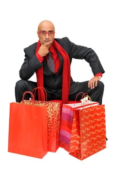Businessman posing with shopping bags isolated in white