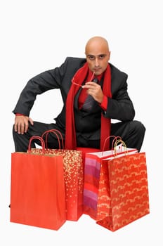 Businessman posing with shopping bags isolated in white