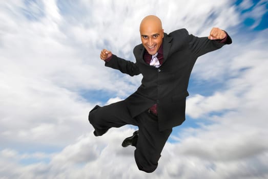 Powerful and happy businessman jumping in the sky