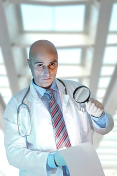 Investigator with magnifierl in his lab