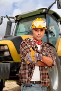 Worker with tractor on the background