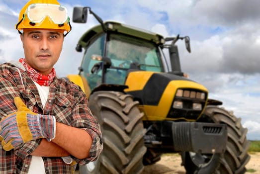 Worker with tractor on the background