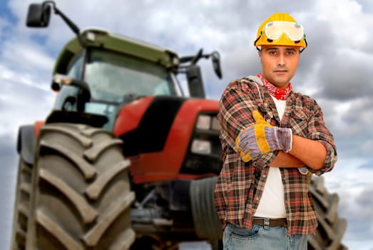 Worker with tractor on the background