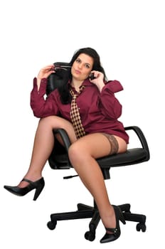 Sexy businesswoman in a chair with tie and stockings isolated in white