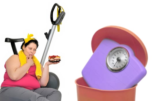 Large woman loking at a cake with weight scale in the garbage