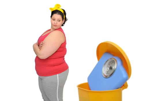 Large woman loking at a weight scale in the garbage