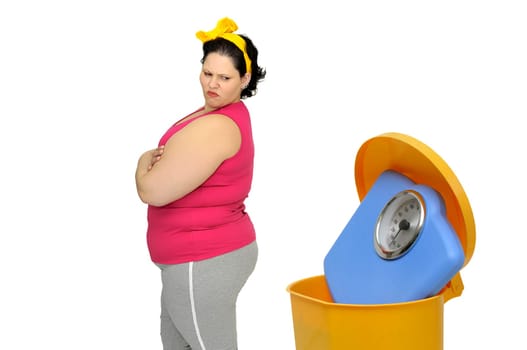 Large woman loking at a weight scale in the garbage