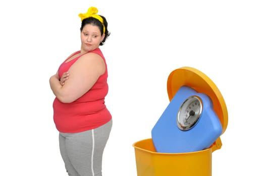Large woman loking at a weight scale in the garbage