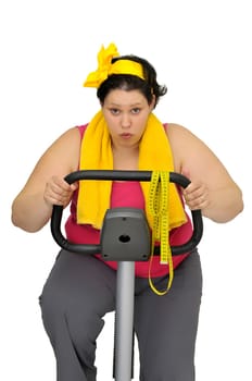 Large girl with fitness bicycle isolated in white