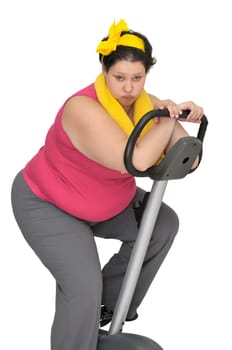 Large girl with fitness bicycle isolated in white