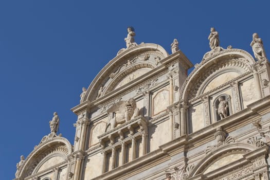 Scuola Grande di San Marco with blue sky in the background (Venice, Italy). Horizontally.