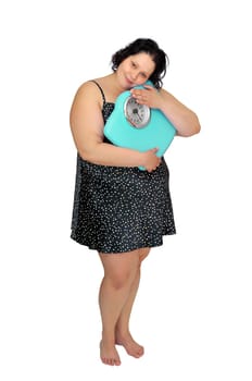 Large girl in nightie holding a scale isolated in white