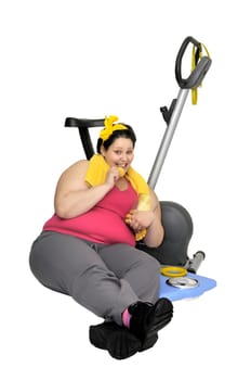 Large girl with fitness bicycle eating cookies isolated in white