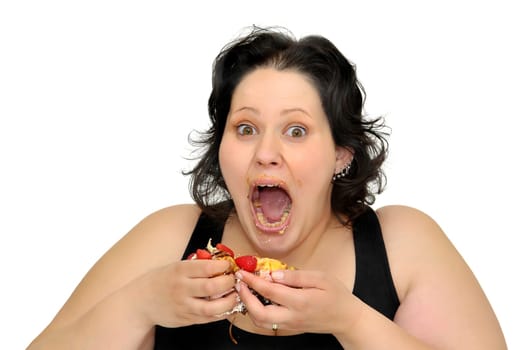 Beautiful large girl laughing with cake remainings in her hand