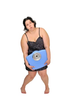 Large girl in nightie holding a scale isolated in white